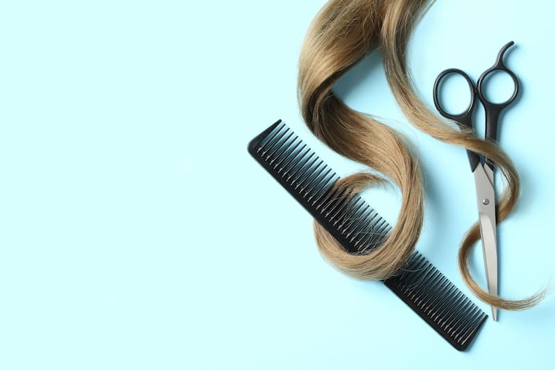 Hair wrapping around a comb and a scissor